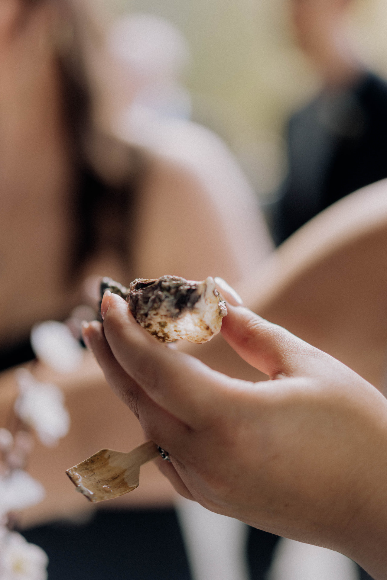 Guest holding an oyster shell at a private party